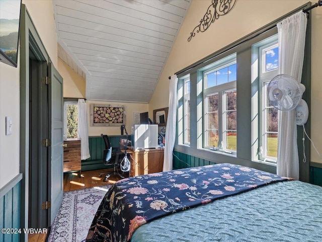 bedroom with multiple windows, wood ceiling, lofted ceiling, and hardwood / wood-style flooring