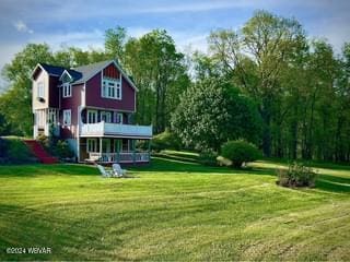 back of house with a lawn