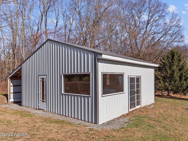 view of outbuilding featuring a yard