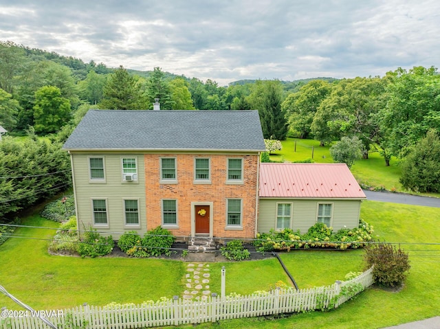 colonial inspired home with a front yard