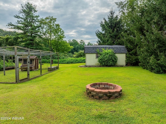 view of yard with a storage unit and an outdoor fire pit