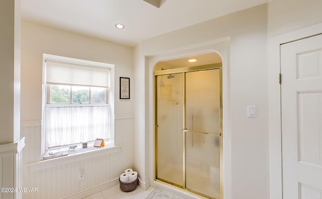 bathroom featuring tile patterned floors, a healthy amount of sunlight, and walk in shower