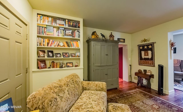 sitting room with dark wood-type flooring