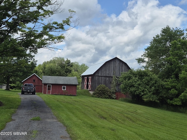 3510 Rt 184, Trout Run, PA 17771 - view of home's exterior featuring a barn, an outdoor structure, a yard, asphalt driveway, and a garage