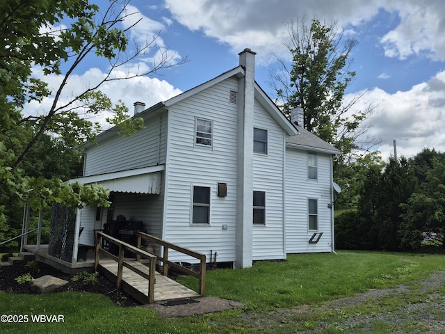 3510 Rt 184, Trout Run, PA 17771 - view of side of home featuring a chimney and a lawn