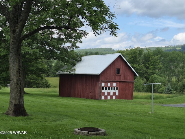 3510 Rt 184, Trout Run, PA 17771 - view of pole building featuring a yard, an outdoor fire pit, a view of trees, and driveway