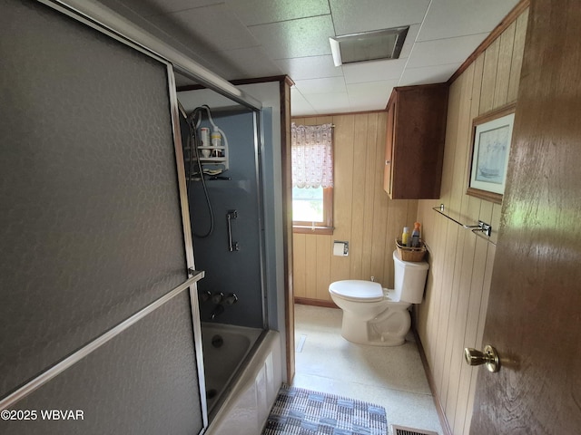 3510 Rt 184, Trout Run, PA 17771 - bathroom featuring wooden walls, shower / bath combination with glass door, and a drop ceiling
