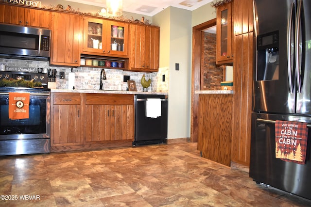 201 Richey St, Lock Haven, PA 17745 - kitchen with stainless steel appliances, a sink, brown cabinets, backsplash, and crown molding