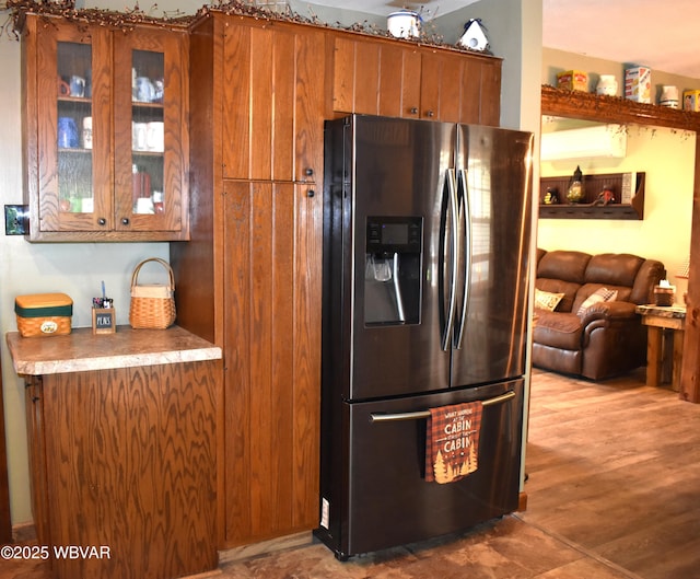 201 Richey St, Lock Haven, PA 17745 - kitchen featuring stainless steel refrigerator with ice dispenser, brown cabinetry, glass insert cabinets, and open floor plan