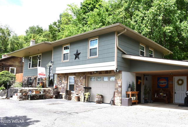 201 Richey St, Lock Haven, PA 17745 - raised ranch with stone siding, an attached garage, driveway, and a chimney