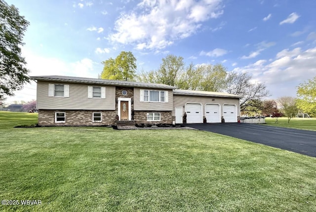 150 Pine Creek Ave, Jersey Shore, PA 17740 - split foyer home with asphalt driveway, a front yard, and an attached garage