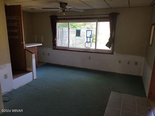 spare room with a paneled ceiling and ceiling fan