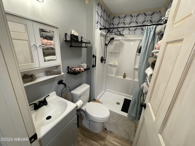 bathroom featuring curtained shower, toilet, vanity, and hardwood / wood-style flooring