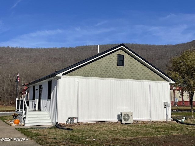 view of side of home with ac unit