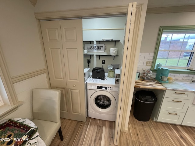 laundry room with light wood-type flooring and washer / clothes dryer