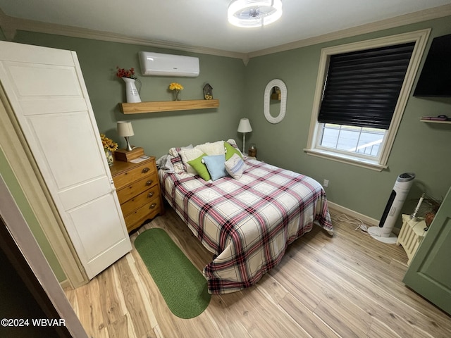 bedroom featuring light hardwood / wood-style floors, an AC wall unit, and ornamental molding