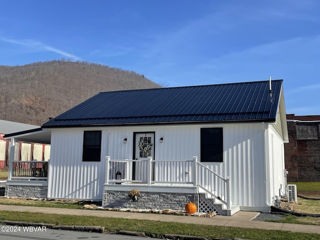 view of front of home with covered porch and central AC unit