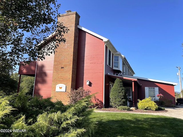 view of side of property with a yard