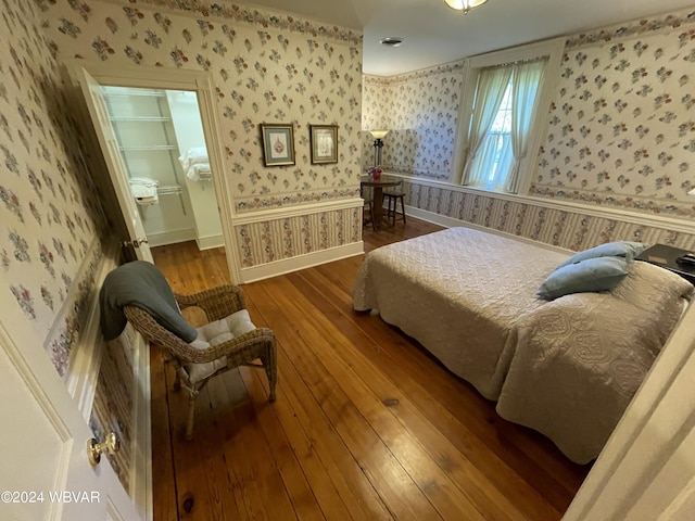 159 Harveys Ln, Milton, PA 17847 - bedroom featuring wallpapered walls, hardwood / wood-style flooring, and a walk in closet