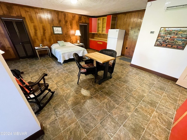 159 Harveys Ln, Milton, PA 17847 - bedroom featuring freestanding refrigerator, wooden walls, a wall unit AC, dark stone finish flooring, and a textured ceiling