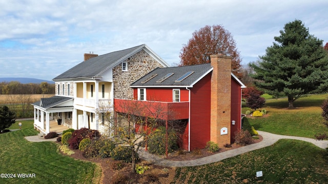 159 Harveys Ln, Milton, PA 17847 - view of property exterior featuring a chimney, a lawn, stone siding, and a balcony