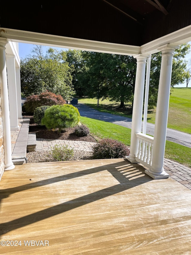 deck with a lawn and a porch