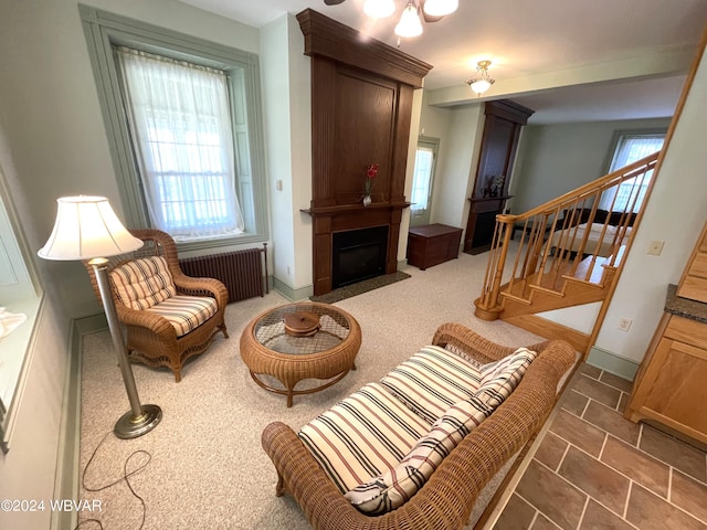 159 Harveys Ln, Milton, PA 17847 - living room featuring healthy amount of natural light, stairway, radiator heating unit, and a large fireplace