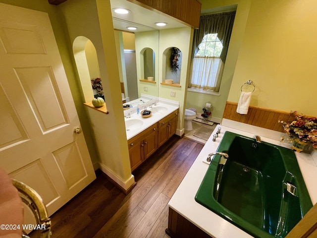 bathroom with toilet, vanity, and hardwood / wood-style flooring