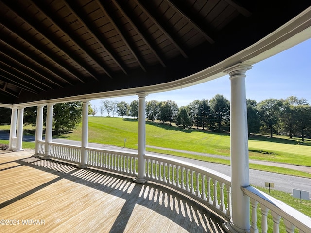 wooden deck featuring a yard and covered porch