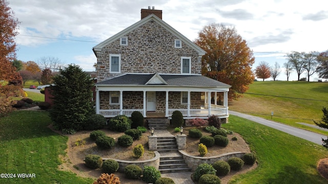 159 Harveys Ln, Milton, PA 17847 - view of front of house with stone siding, a chimney, a front lawn, a porch, and stairway
