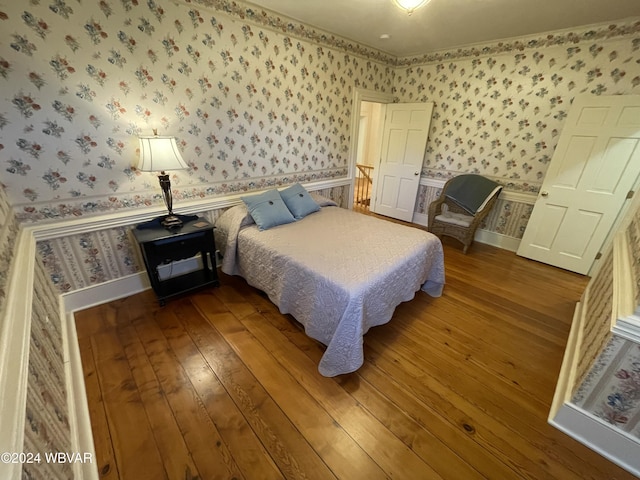159 Harveys Ln, Milton, PA 17847 - bedroom featuring wallpapered walls, wood-type flooring, and wainscoting