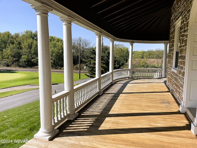 wooden terrace featuring covered porch