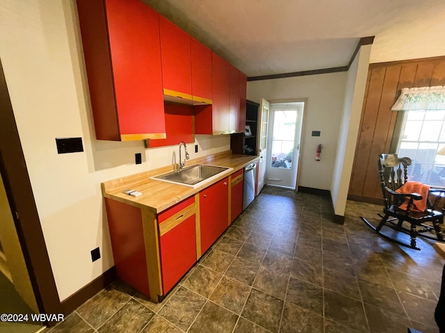 kitchen featuring wooden counters, stainless steel dishwasher, crown molding, and sink