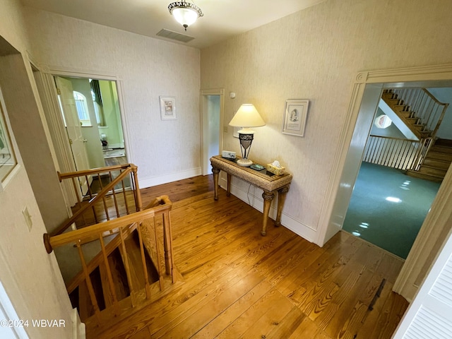 corridor with hardwood / wood-style floors