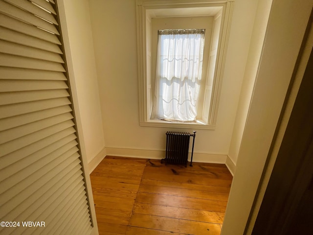 interior space featuring radiator heating unit and wood-type flooring