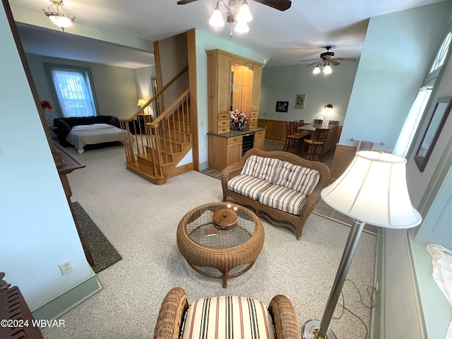 living room with wine cooler, ceiling fan, and carpet floors