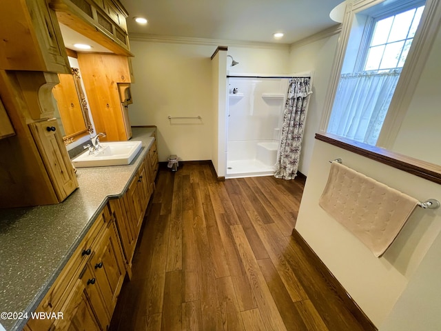 bathroom with a shower with shower curtain, vanity, hardwood / wood-style flooring, and ornamental molding