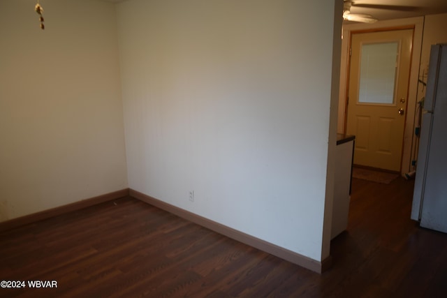 unfurnished room featuring dark hardwood / wood-style flooring and ceiling fan