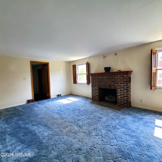 unfurnished living room with a fireplace and carpet floors