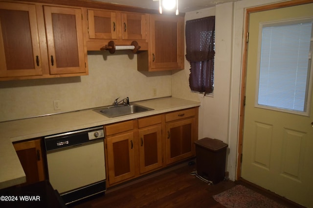 kitchen featuring dark hardwood / wood-style flooring, white dishwasher, and sink