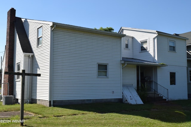 back of house with central air condition unit