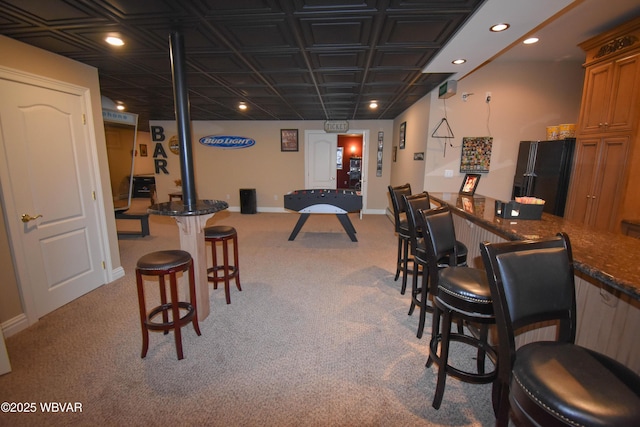 interior space featuring baseboards, light colored carpet, and recessed lighting