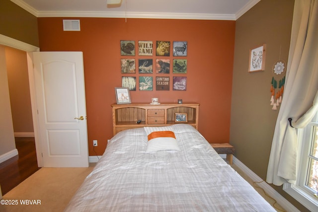bedroom featuring ornamental molding, baseboards, and visible vents