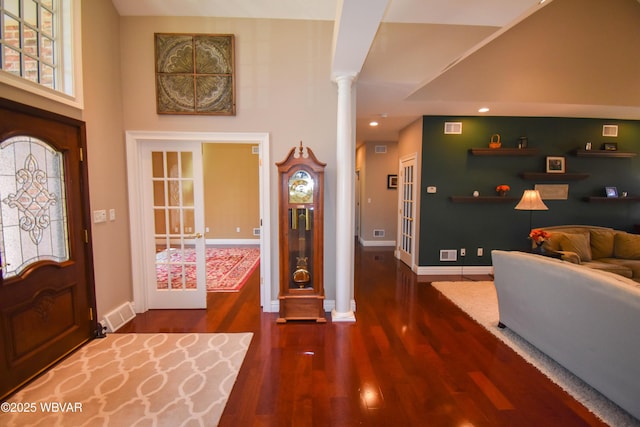 foyer with visible vents, baseboards, wood finished floors, recessed lighting, and decorative columns