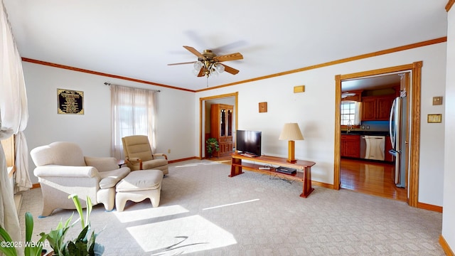 carpeted living room with sink, crown molding, and ceiling fan