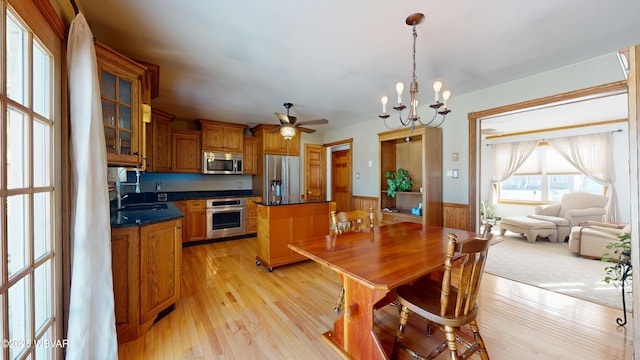 dining room with light hardwood / wood-style floors, sink, and a notable chandelier