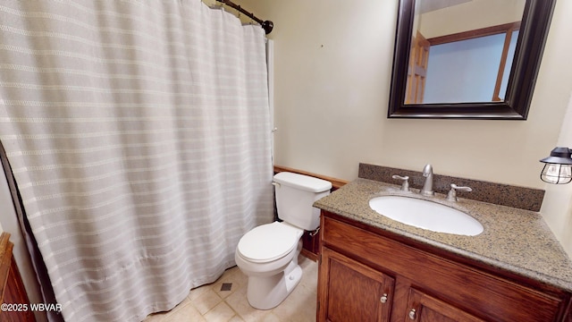 bathroom featuring vanity, tile patterned floors, and toilet