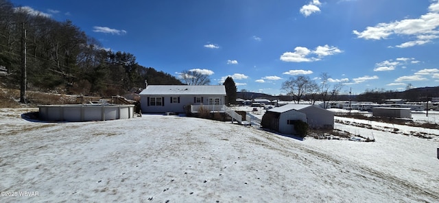 view of snow covered back of property