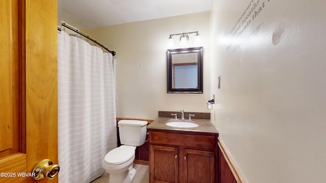 bathroom with a shower with curtain, vanity, tile patterned floors, and toilet