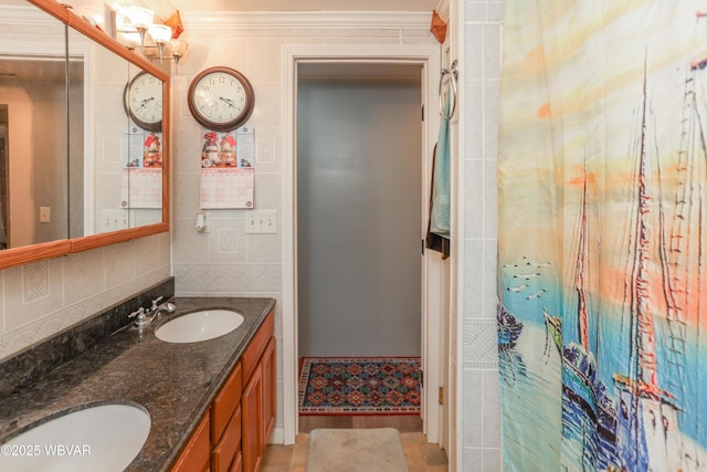 bathroom with double vanity, crown molding, and a sink